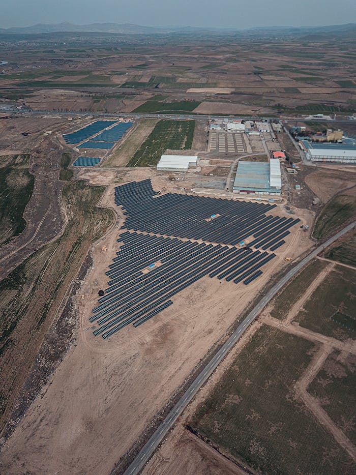 Expansive view of solar panels in a rural landscape, showcasing renewable energy.